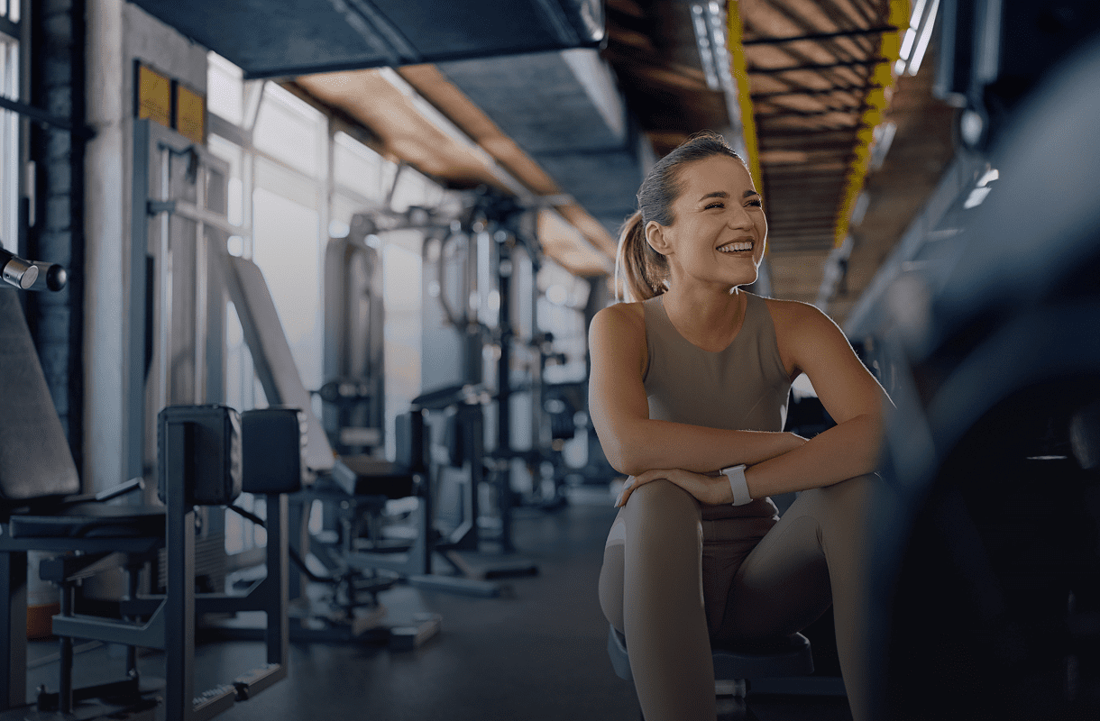 Woman smiling in a gym setting